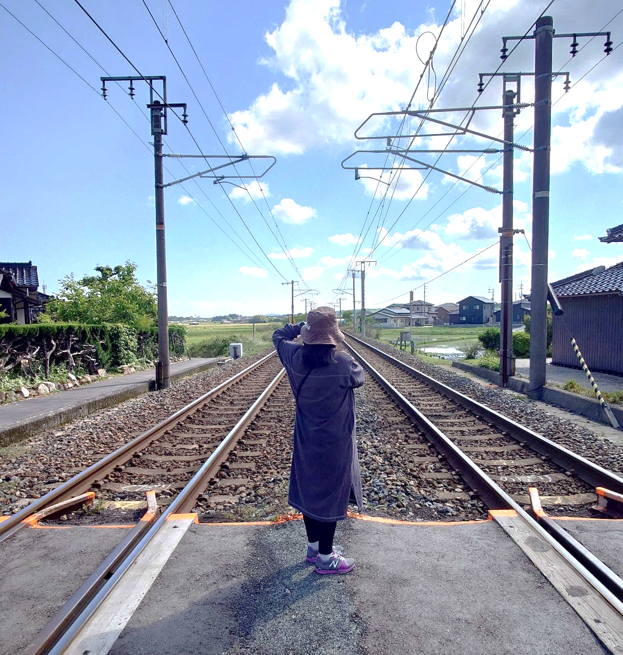 画像：山口市の踏切で妻の後姿を撮影。変哲もない景色でも人工物が少なくて写真映えします